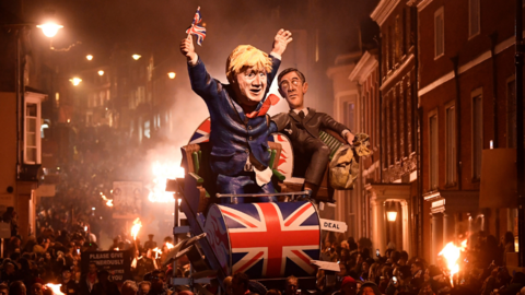 An effigy of former Prime Minister Boris Johnson holding a Union Jack flag and Jacob Rees-Mogg being paraded through Lewes High Street. 