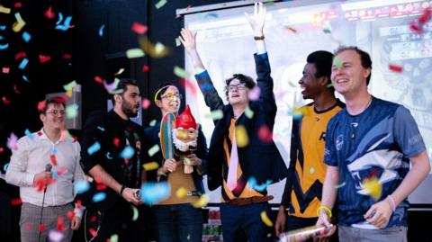 Six boys from the Roehampton esports team celebrating a win at a competition.