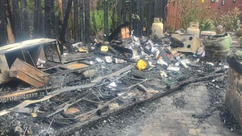 Burnt out shed and seating area