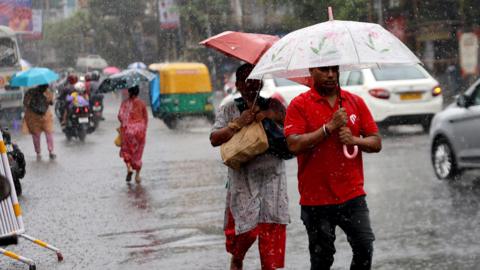 Indian commuters walk during rainfall in Kolkata, India, 23 October 2024. Mandatory Credit: Photo by PIYAL ADHIKARY/EPA-EFE/REX/Shutterstock (14809633c)