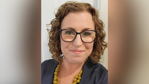 Nicola Zurawliw, a Nottinghamshire Healthcare nurse, wearing glasses, a blue top and yellow beads