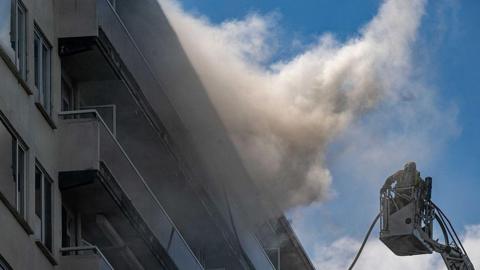 Firefighters pictured at the scene of a fire in an apartment building in the August Vermeylenlaan street in Antwerp