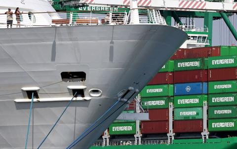 Evergreen container ship loaded with shipping containers (R) at the Port of Los Angeles on September 26, 2025 in Los Angeles, California. 