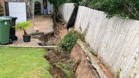 A hole left by the collapsed wall at the property