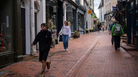 People pass along a street in Royal Tunbridge Wells, England