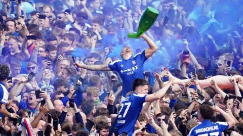 Ipswich players celebrate with fans