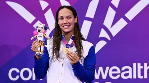 Scotland's Angharad Evans with her swimming gold medal