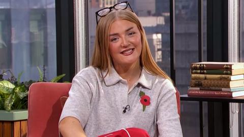 Lauren Jean sits in the Morning Live studio, wearing a grey shirt and a poppy.  
