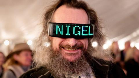 Up close shot of man wearing Nigel glasses