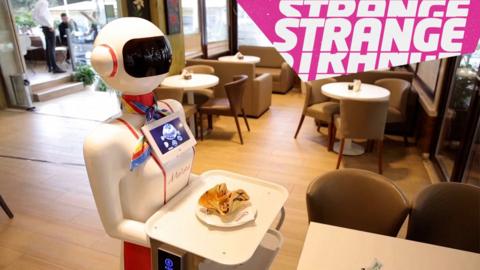 A robot and the Strange News logo