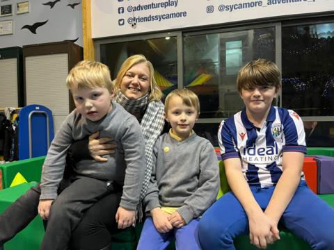 A mum and three sons on the soft play 