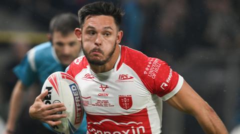 Niall Evalds on a bursting run forward with the ball during a game for Hull KR