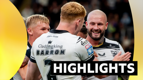 Zak Hardaker (right) holds his hand out and smiles at team-mate Harvey Barron