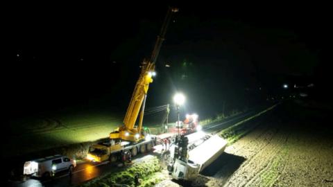 Crane in a field in the dark