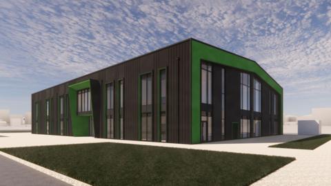 Artist's impression of the hub. It is painted black and green and has a number of windows stretching across two storeys. It looks like it is clad in something mimicking wood, but is just a drawing so will not look a great deal like the finished building. It has the air of a typical business centre, not quite a shed but somewhat clinical, functional like a teaching block or library at a new university.
