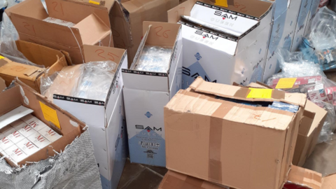 Dozens of half-opened cardboard boxes containing tobacco products 