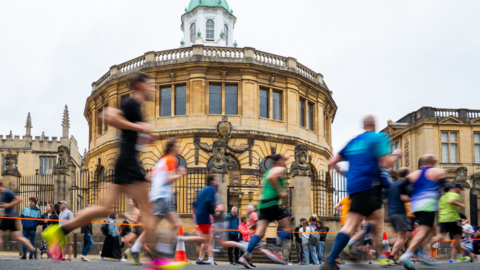 Hoards of runners pass Oxford's Sheldonian Theatre.