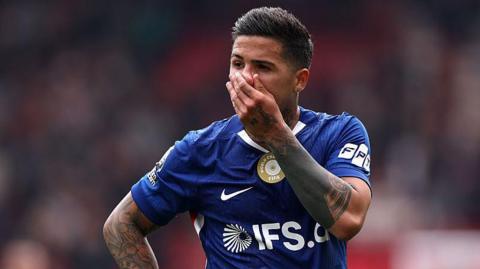 Enzo Fernandez looking disappointed with his hand on his face during a Chelsea game
