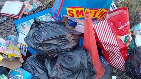 A pile of rubbish that was dumped by a rouge trader in Kirby in Ashfield is pictured. It includes bags, a traffic cone and cardboard boxes
