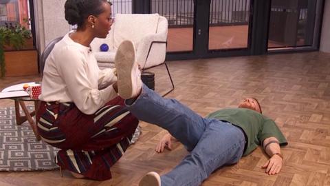 Still from a clip of Morning Live on relieving back pain.