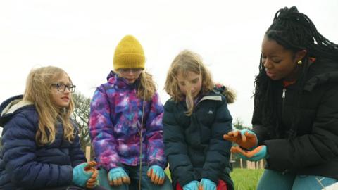 Children and Emma-Louise help to plant saplings in Bristol