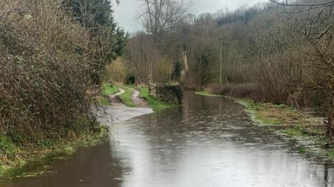 A flooded, rural road 