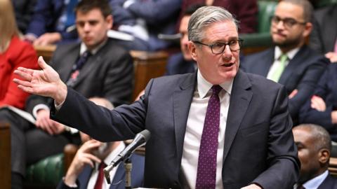 Prime Minister Keir Starmer speaking at the dispatch box during prime minister's questions in the house of commons with MPs behind him