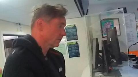 Paul Doyle at a police station