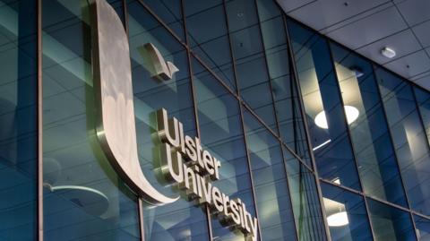A glass building with a sign reading Ulster University