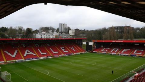 A general view from the corner of one of the stands at The Valley, looking into the empty stadium with just one person on the pitch