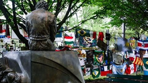 Flags and banners are left at the Ayrton Senna Memorial in Imola