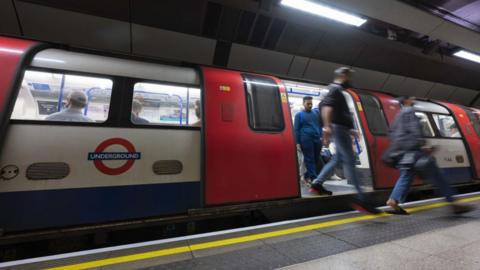 Library image of a Tube train with passengers getting off