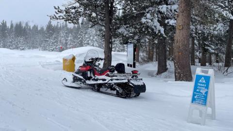 A snowmobile is parked at Alder Creek Adventure Center, one of two sites where search crews were launched to try to locate a group of missing skiers after an avalanche in a backcountry slope of California's Sierra Nevada mountains, in Truckee, California, US.