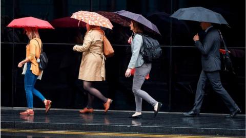 commuters in the rain