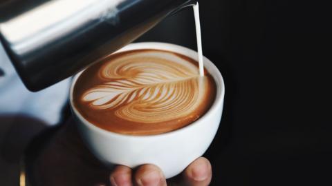 Latte art being poured in a coffee shop