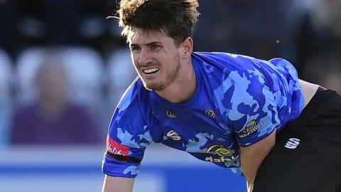George Garton bowling for Sussex