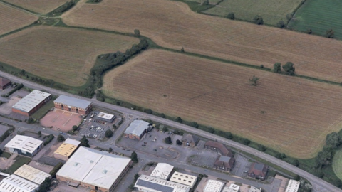 A field seen from above on the edge of a town