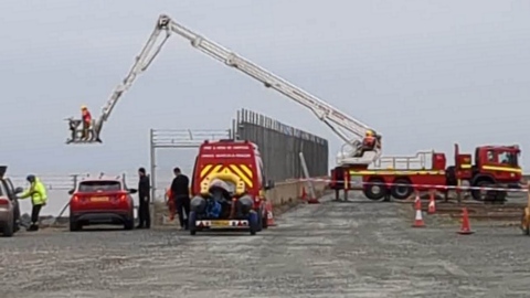 Emergency services attempt to retrieve body off shore