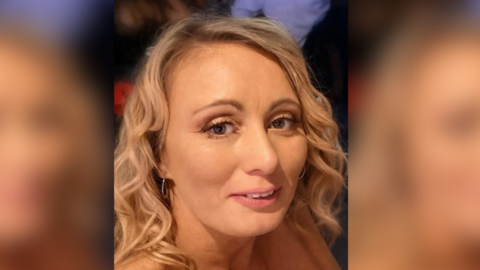 A woman smiling with blonde hair