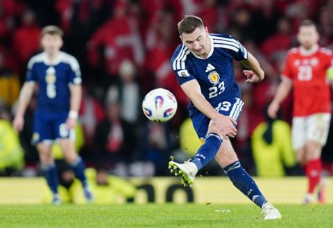 Scotland's Kenny McLean kicks the ball, scoring their side's fourth goal of the game