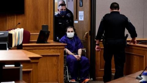 Suspect Ahmad al-Aliwi Al Issa (centre) is brought into the courtroom in Boulder in a wheelchair by police. Photo: 25 March 2021