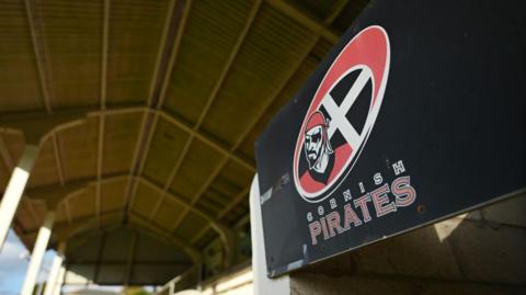 The Cornish Pirates club badge on a board inside the stand at their stadium