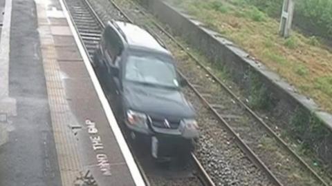 CCTV captures man driving down railway