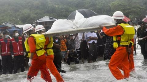 Rescue workers carry the body of a plane crash victim on the shore by SanLann village as the recovery of the dead victims from the crashed Myanmar military Y-8 transport plane arrive near Laung Lone township of southern Tanintharyi region, Myanmar, 08 June 2017.