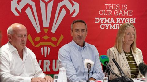 Richard Collier-Keywood, WRU Chairman, Dave Reddin, WRU Director of Rugby and Elite Performance and Abi Tierney, WRU Chief Executive speaking at a press conference