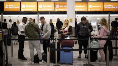 Travellers queue to check in for their EasyJet flights at Gatwick Airport in London, Britain, 31 May 2022