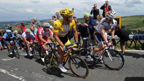 Marcel Kittel wears the yellow jersey as stage two of the Tour de France passes over Holme Moss Moor, Yorkshire.