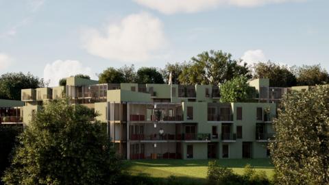 This is a computer-generated image of how the building could look showing a three-storey building, which is a mint green colour. It is surrounded by grass and trees. 