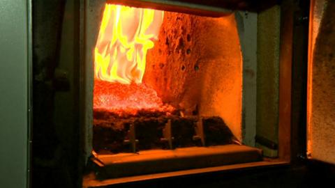 Wood pellets burning in a biomass boiler