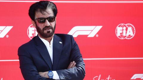 Mohammed Ben Sulayem in sunglasses against a F1 background